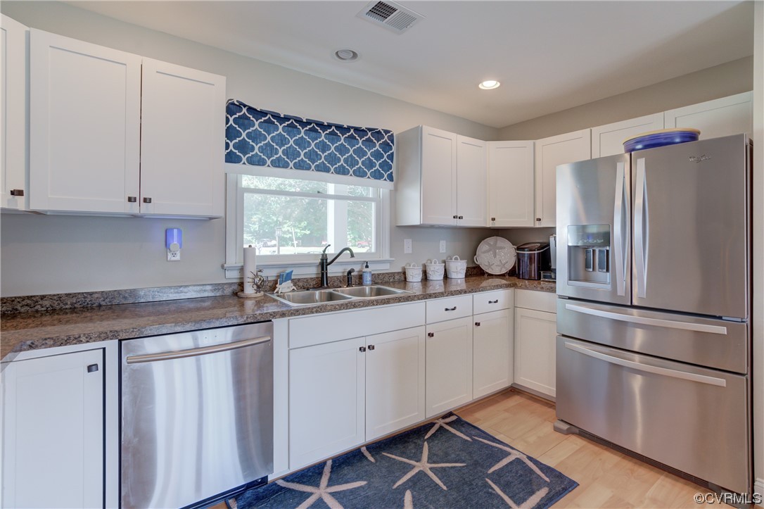 20 South Sioux Road Kilmarnock, VA 22482 - Photo 24 of 46 a kitchen with granite countertop white cabinets and white appliances