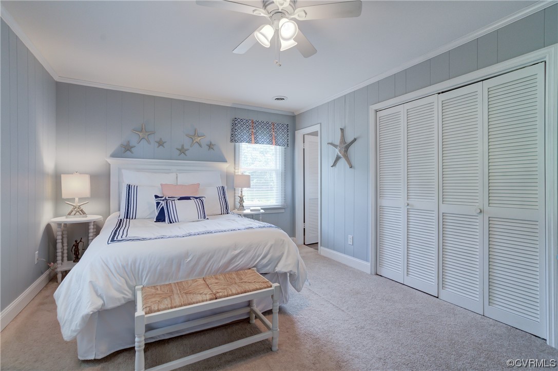 20 South Sioux Road Kilmarnock, VA 22482 - Photo 29 of 46 a bedroom with a bed and a chandelier