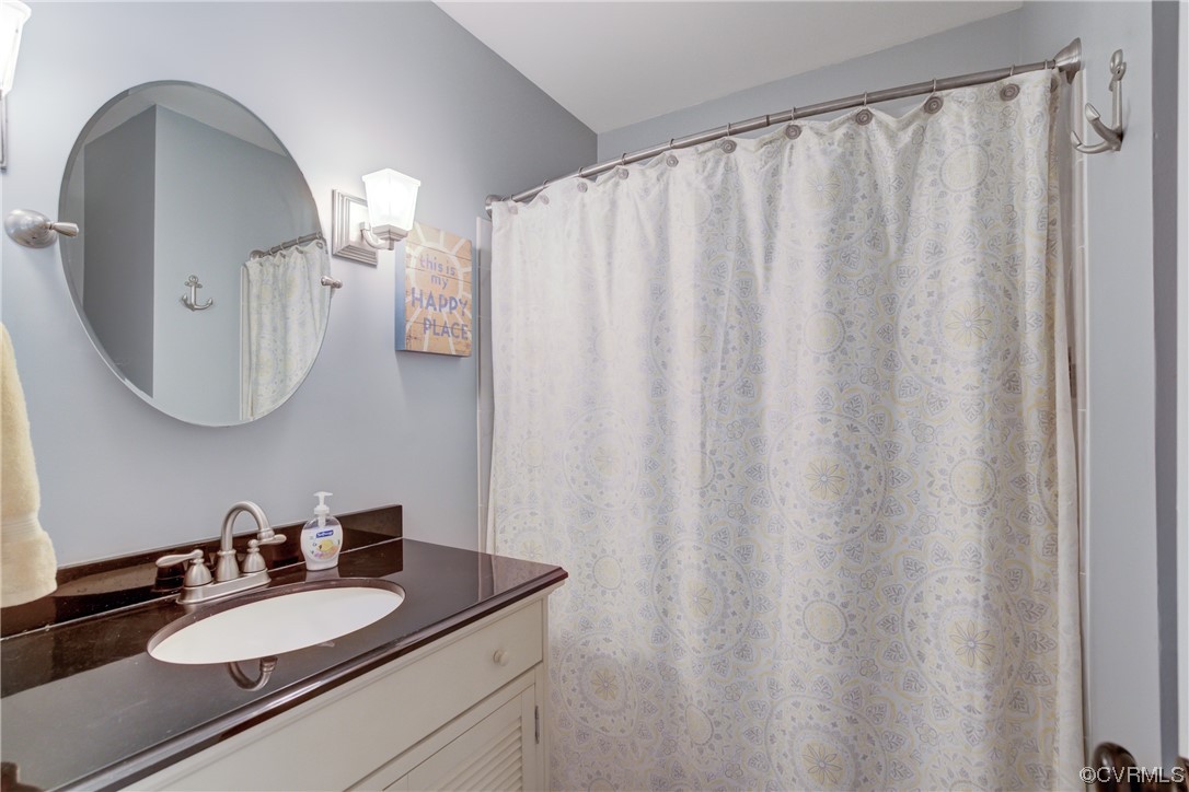20 South Sioux Road Kilmarnock, VA 22482 - Photo 33 of 46 a bathroom with a granite countertop sink and a mirror