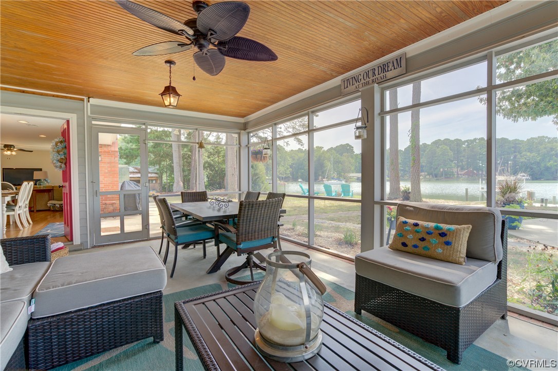 20 South Sioux Road Kilmarnock, VA 22482 - Photo 36 of 46 a living room with furniture and a floor to ceiling window