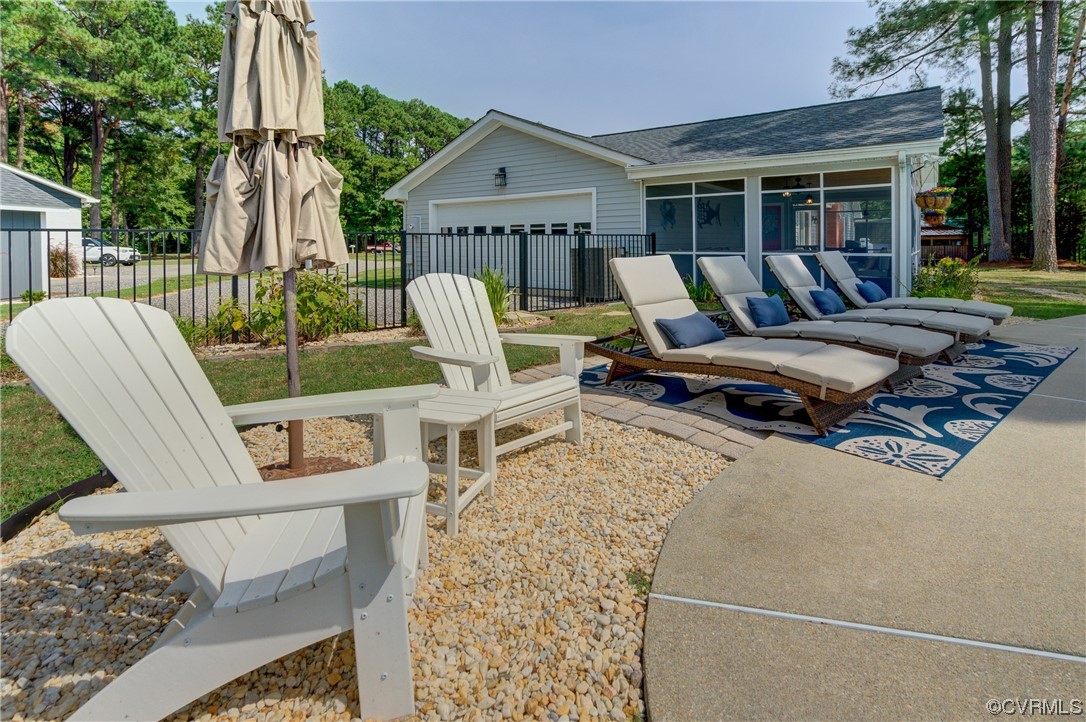 20 South Sioux Road Kilmarnock, VA 22482 - Photo 37 of 46 a view of a patio with table and chairs with wooden floor and fence