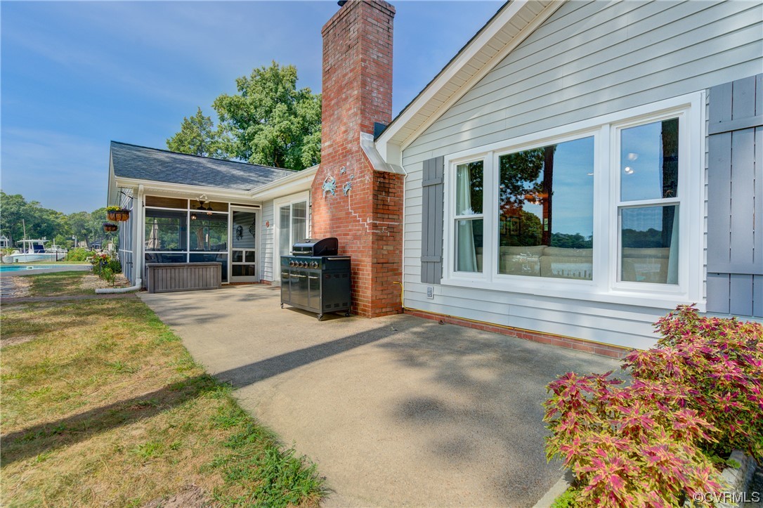 20 South Sioux Road Kilmarnock, VA 22482 - Photo 40 of 46 a view of a house with a patio and a yard