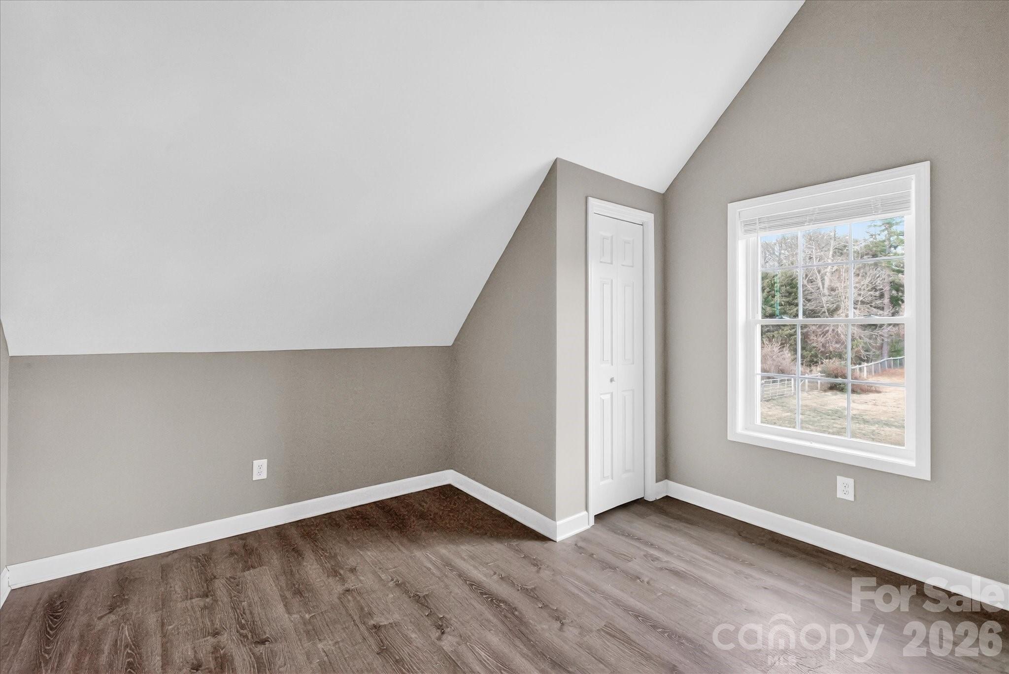 2221 Waxhaw-Marvin Road Waxhaw, NC 28173 - Photo 17 of 30 an empty room with wooden floor and windows