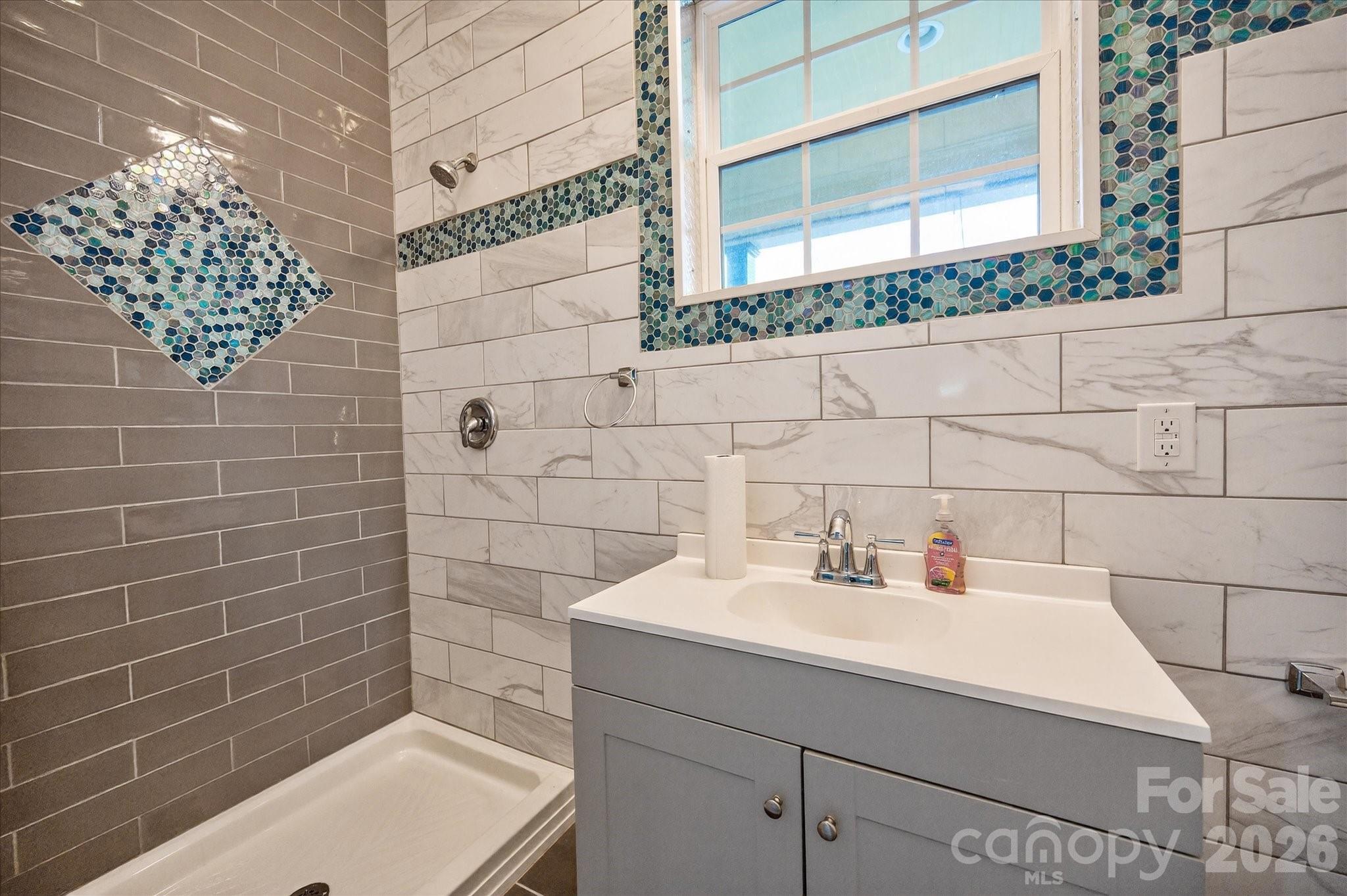 2221 Waxhaw-Marvin Road Waxhaw, NC 28173 - Photo 27 of 30 a bathroom with a sink and a mirror