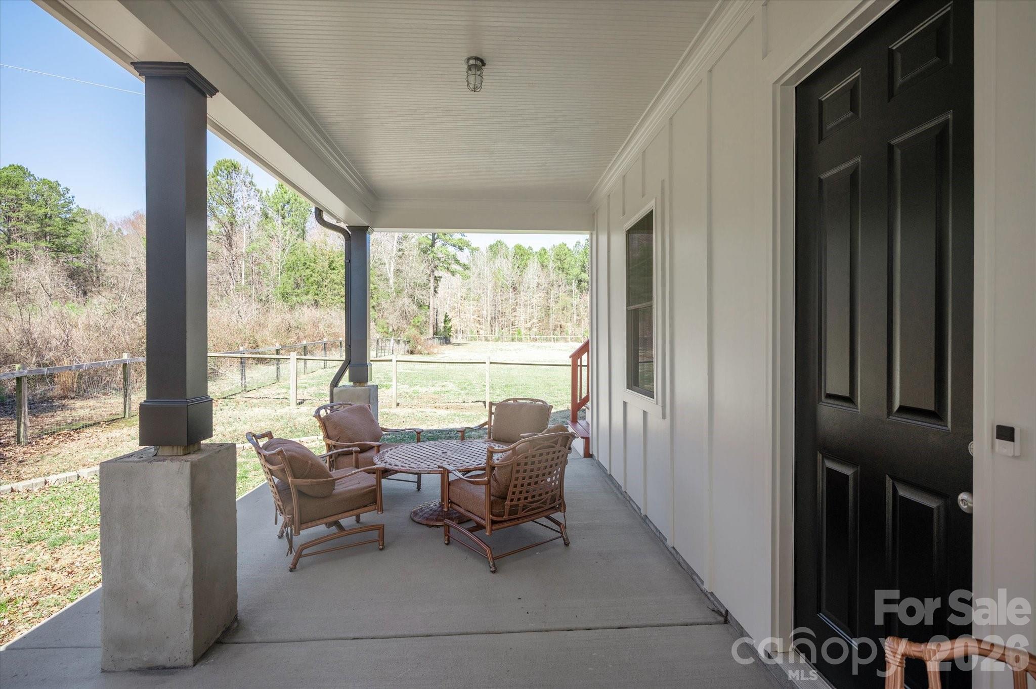 2221 Waxhaw-Marvin Road Waxhaw, NC 28173 - Photo 28 of 30 a living room with furniture and a floor to ceiling window