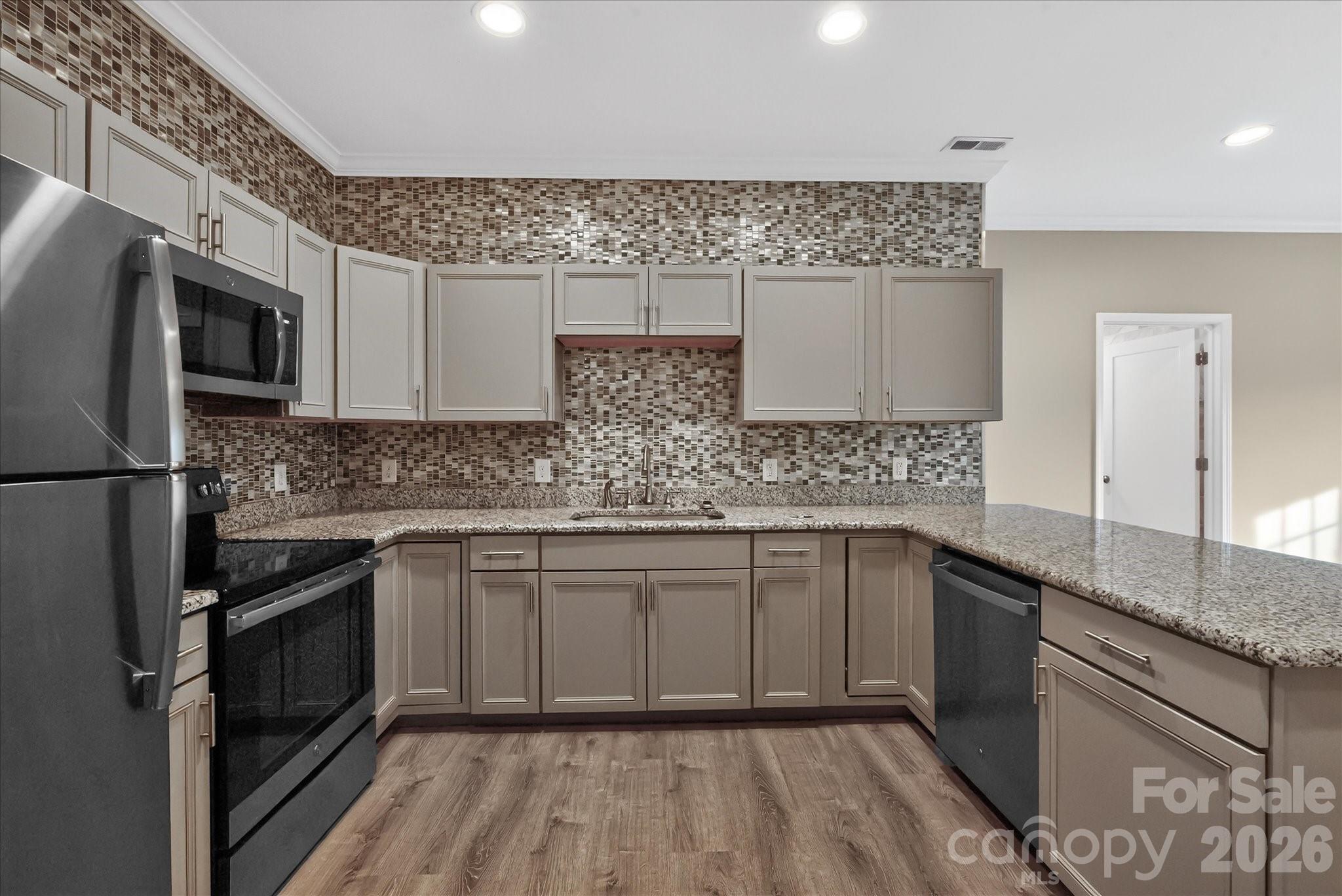 2221 Waxhaw-Marvin Road Waxhaw, NC 28173 - Photo 6 of 30 a kitchen with stainless steel appliances granite countertop a sink stove and microwave