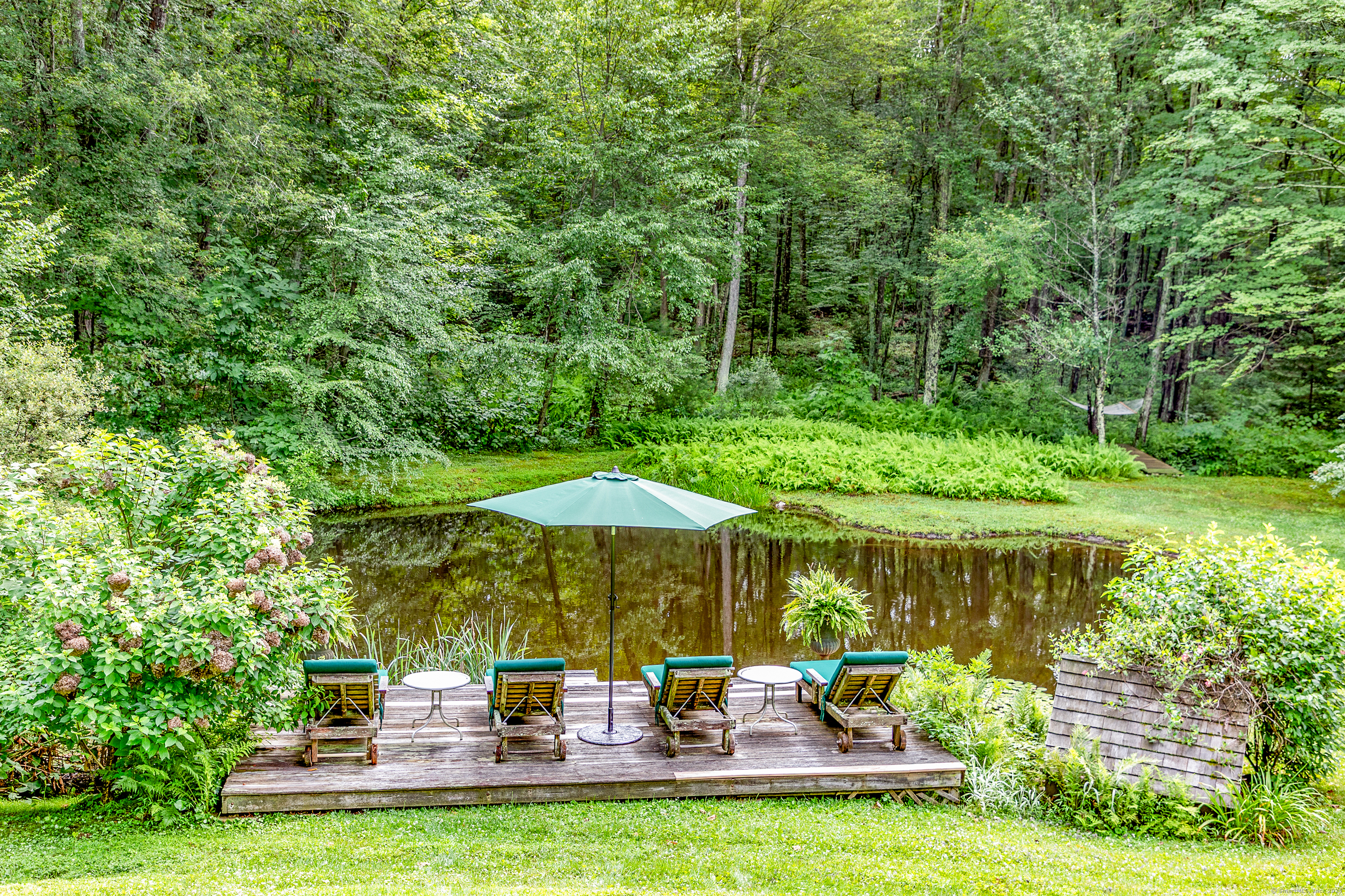 50 Southbury Road Roxbury, CT 06783 - Photo 4 of 31 a view of a table and chairs under an umbrella