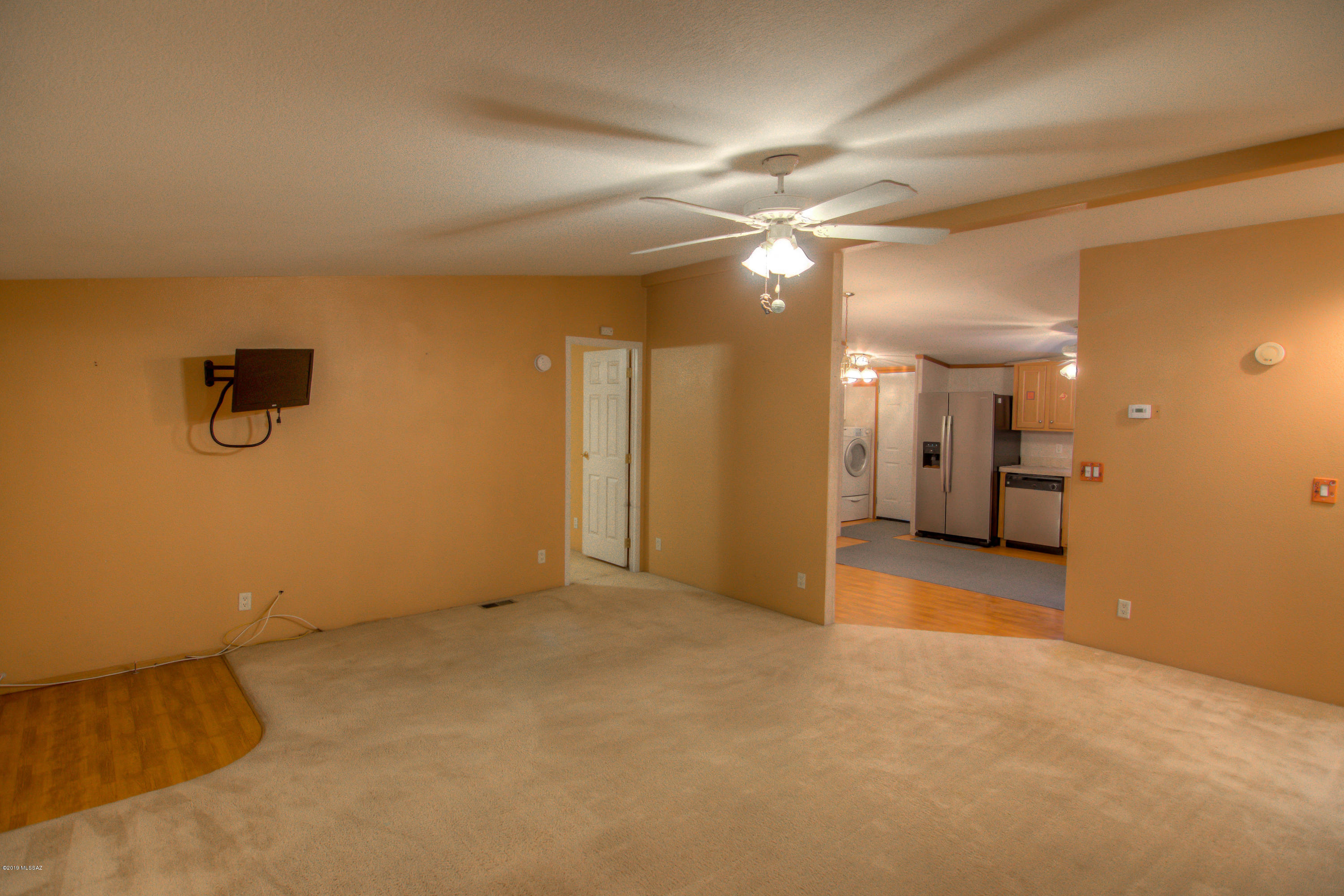 263 East Roger Road Tucson, AZ 85705 - Photo 9 of 31 an empty room with a empty space and a ceiling fan
