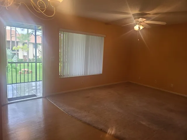 an empty room with windows and closet