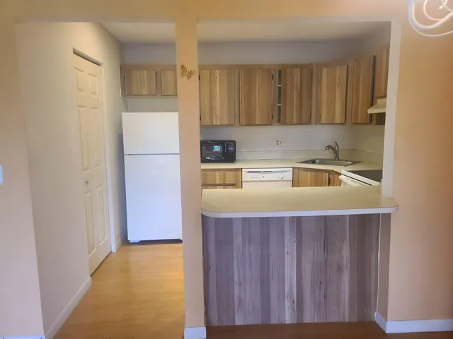 a utility room with cabinets washer and dryer