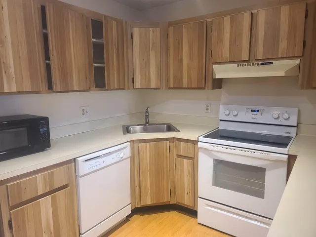 a bathroom with a refrigerator and a sink