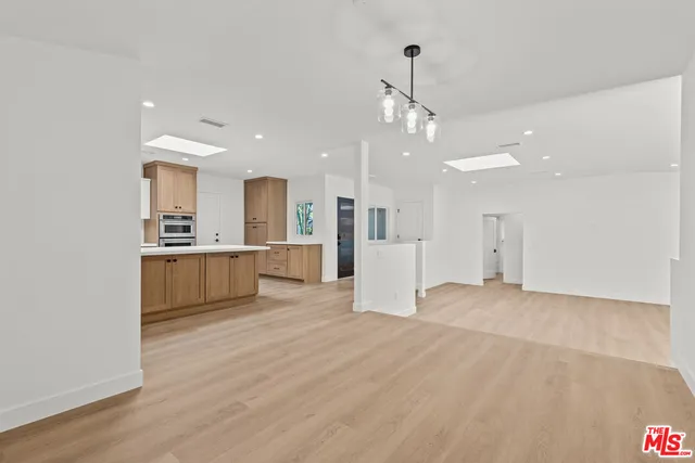 a view of a kitchen with a sink and a refrigerator