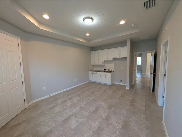 a view of house with backyard and garden