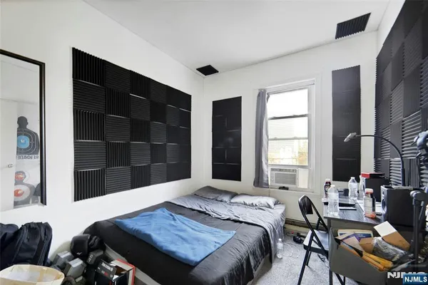 a bedroom with furniture and a window