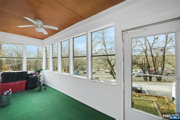 a living room with furniture and a floor to ceiling window
