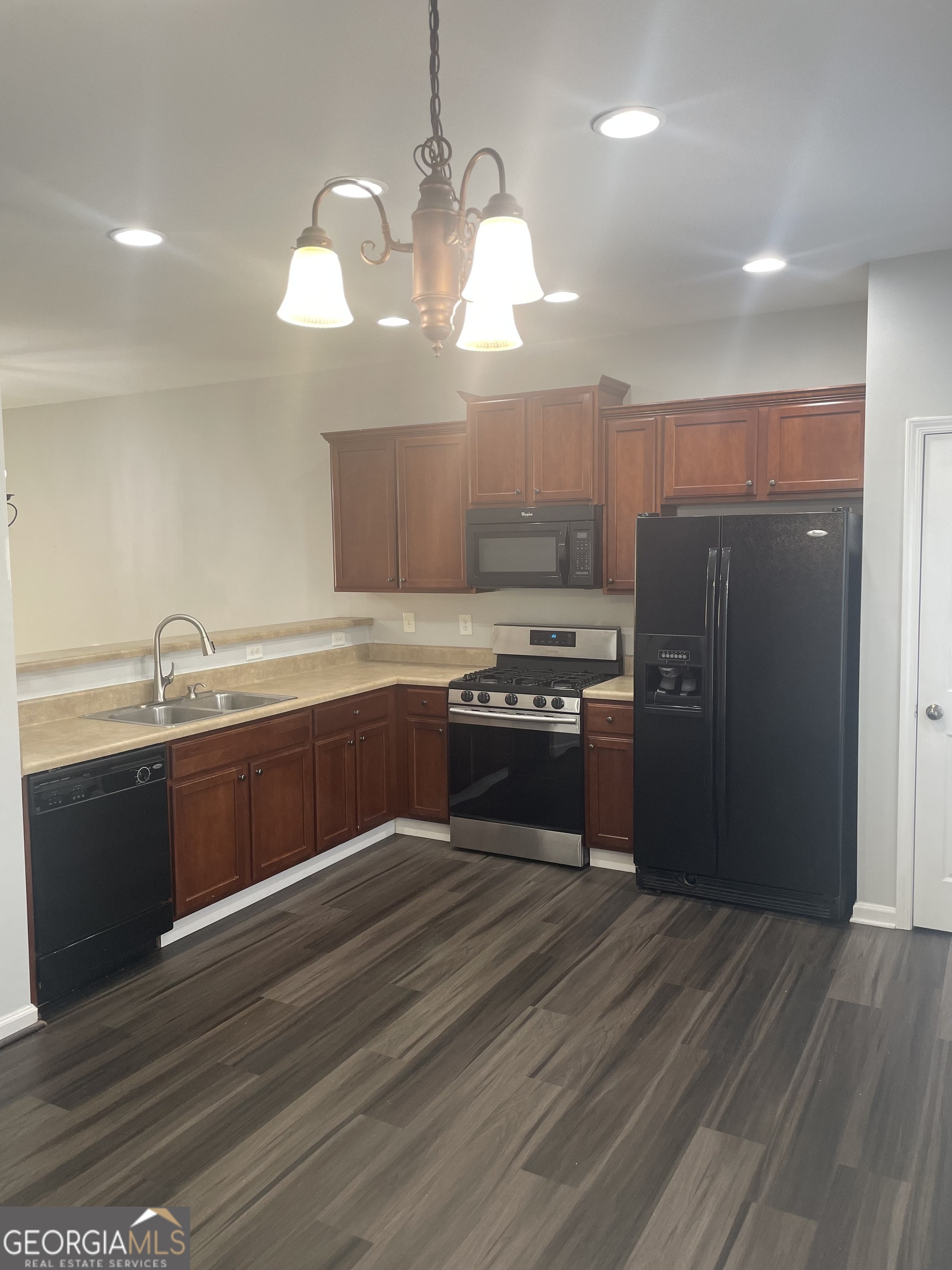 3640 Utoy Drive Southwest South Fulton, GA 30331 - Photo 13 of 26 a kitchen with stainless steel appliances granite countertop a sink counter space and wooden floor
