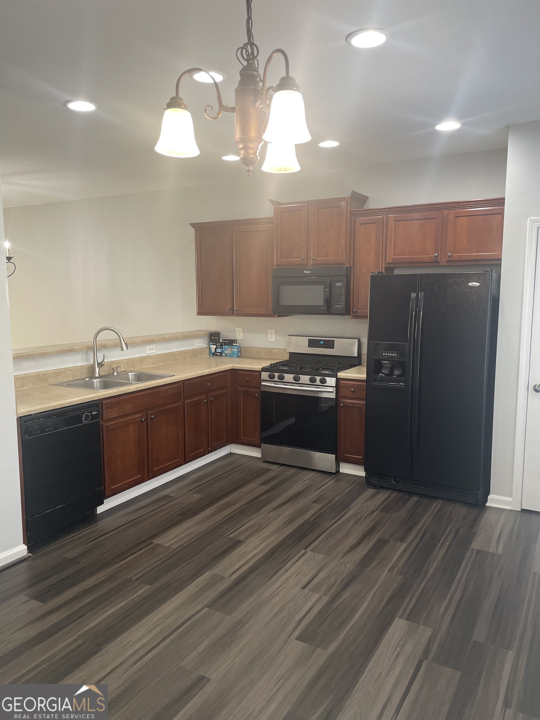 3640 Utoy Drive Southwest South Fulton, GA 30331 - Photo 14 of 26 a kitchen with stainless steel appliances granite countertop a sink a stove a refrigerator with wooden floors and cabinets