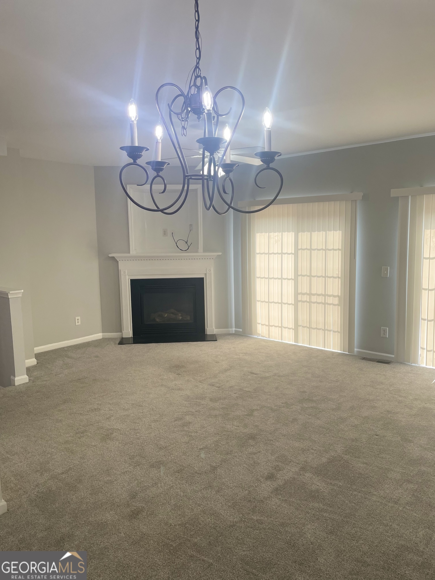 3640 Utoy Drive Southwest South Fulton, GA 30331 - Photo 7 of 26 a view of an empty room with a fireplace and a window