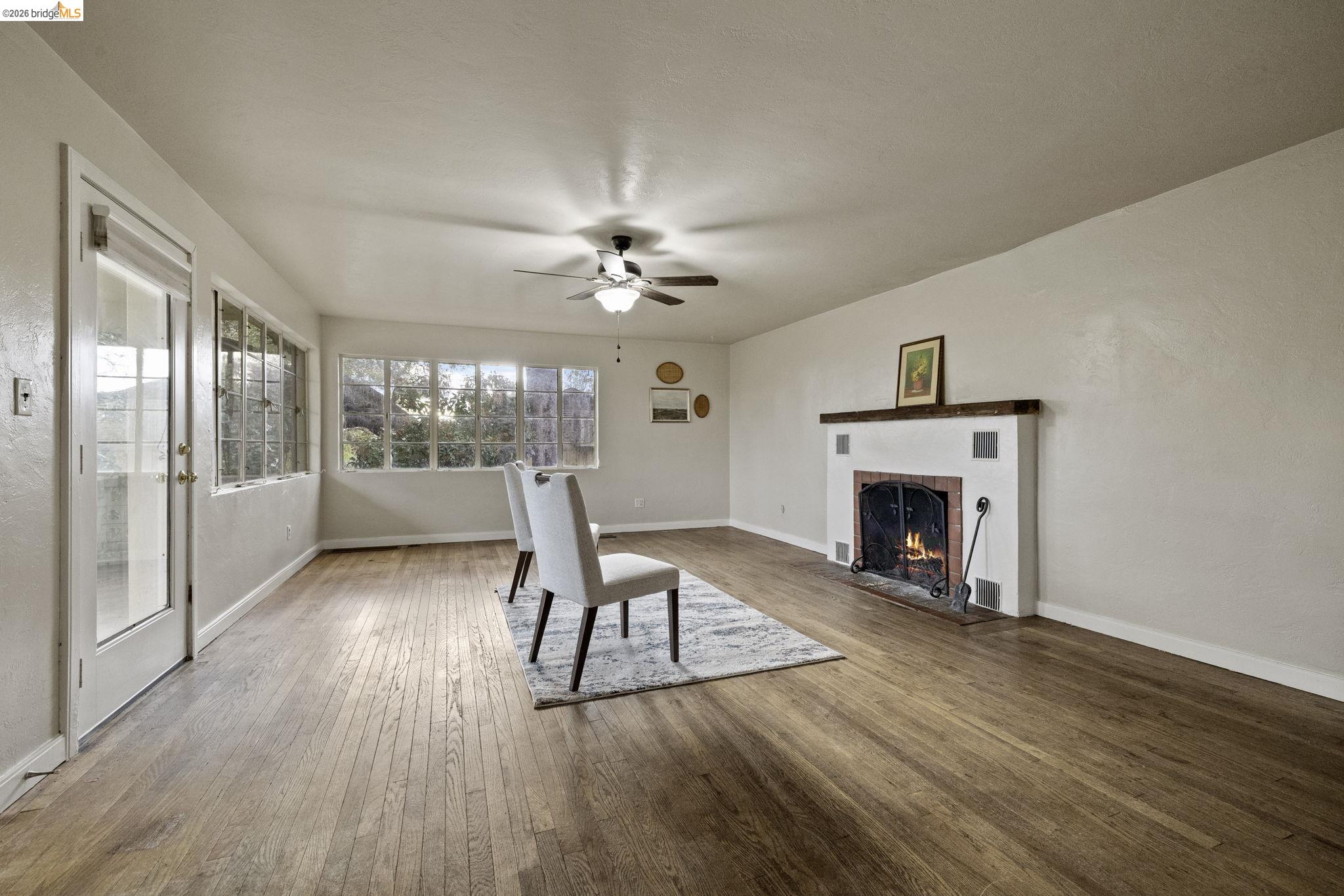 299 Summit Avenue Sonora, CA 95370 - Photo 15 of 38 Living room with a fireplace, wood-type flooring, and ceiling fan