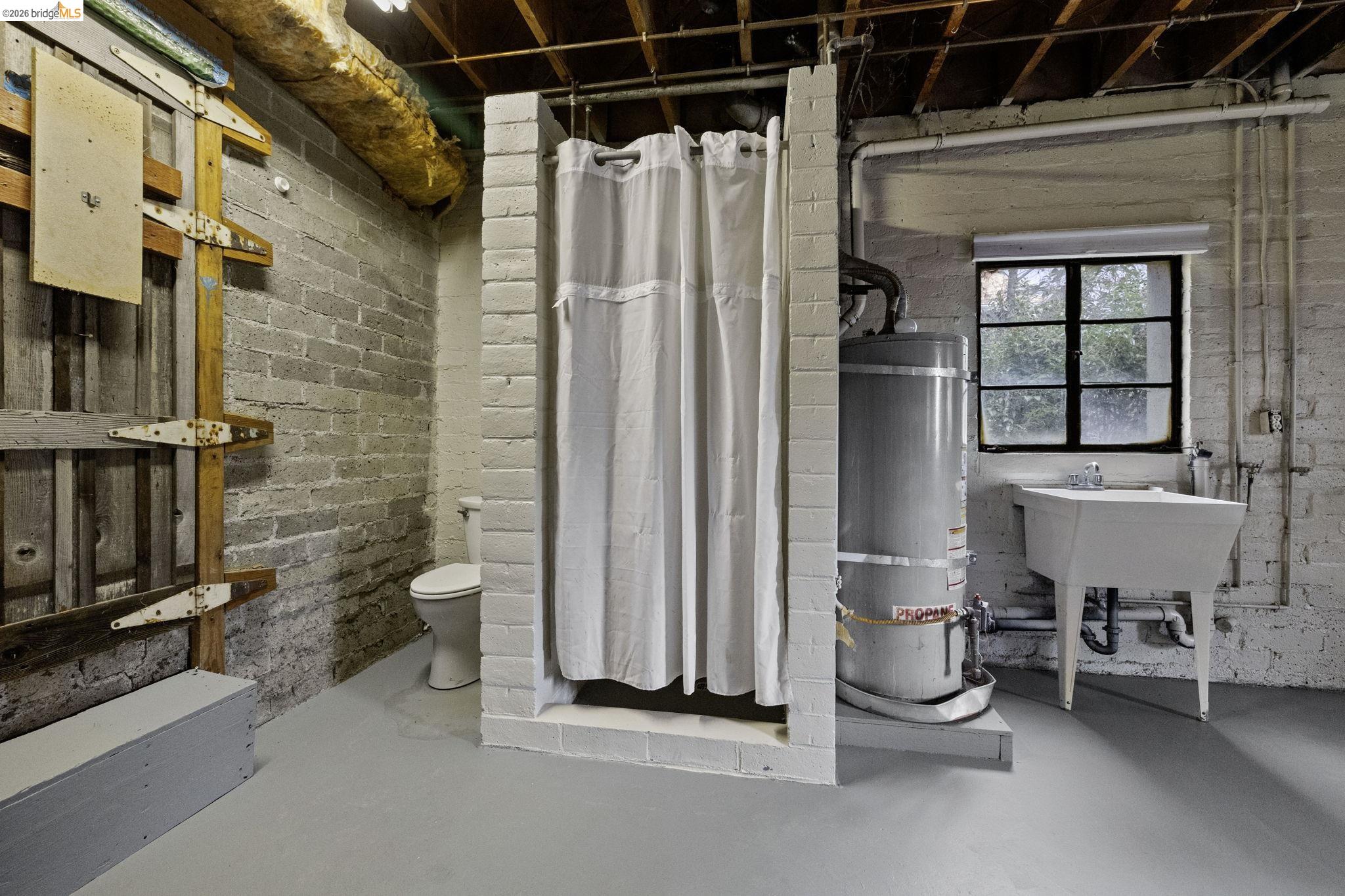 299 Summit Avenue Sonora, CA 95370 - Photo 20 of 38 Bathroom with concrete flooring, water heater, and a shower stall