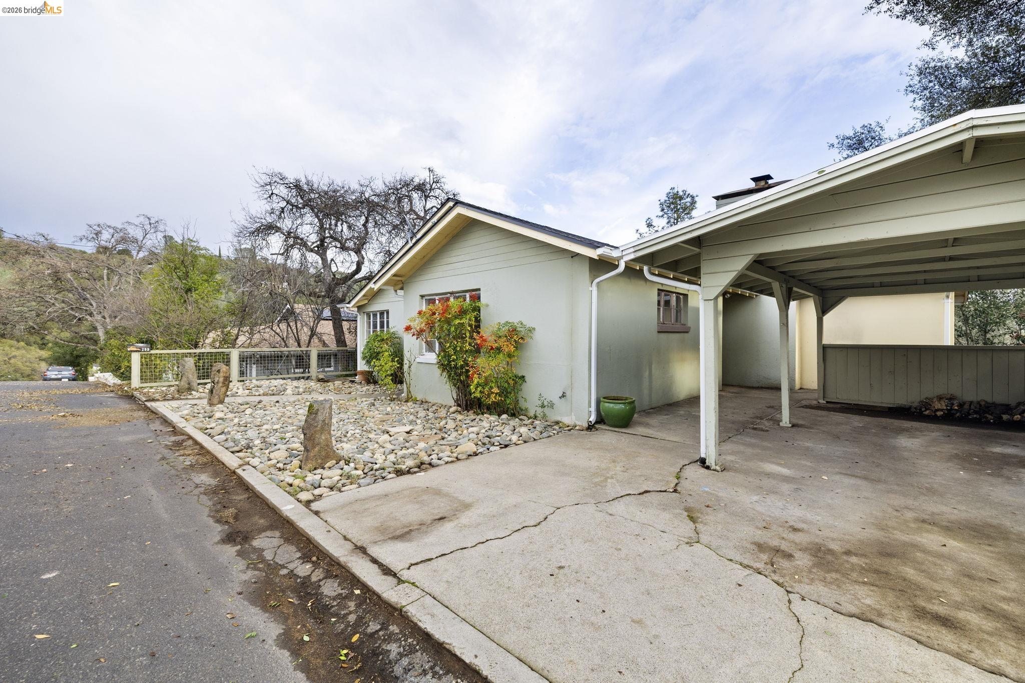 299 Summit Avenue Sonora, CA 95370 - Photo 28 of 38 View of side of home with concrete driveway and a carport