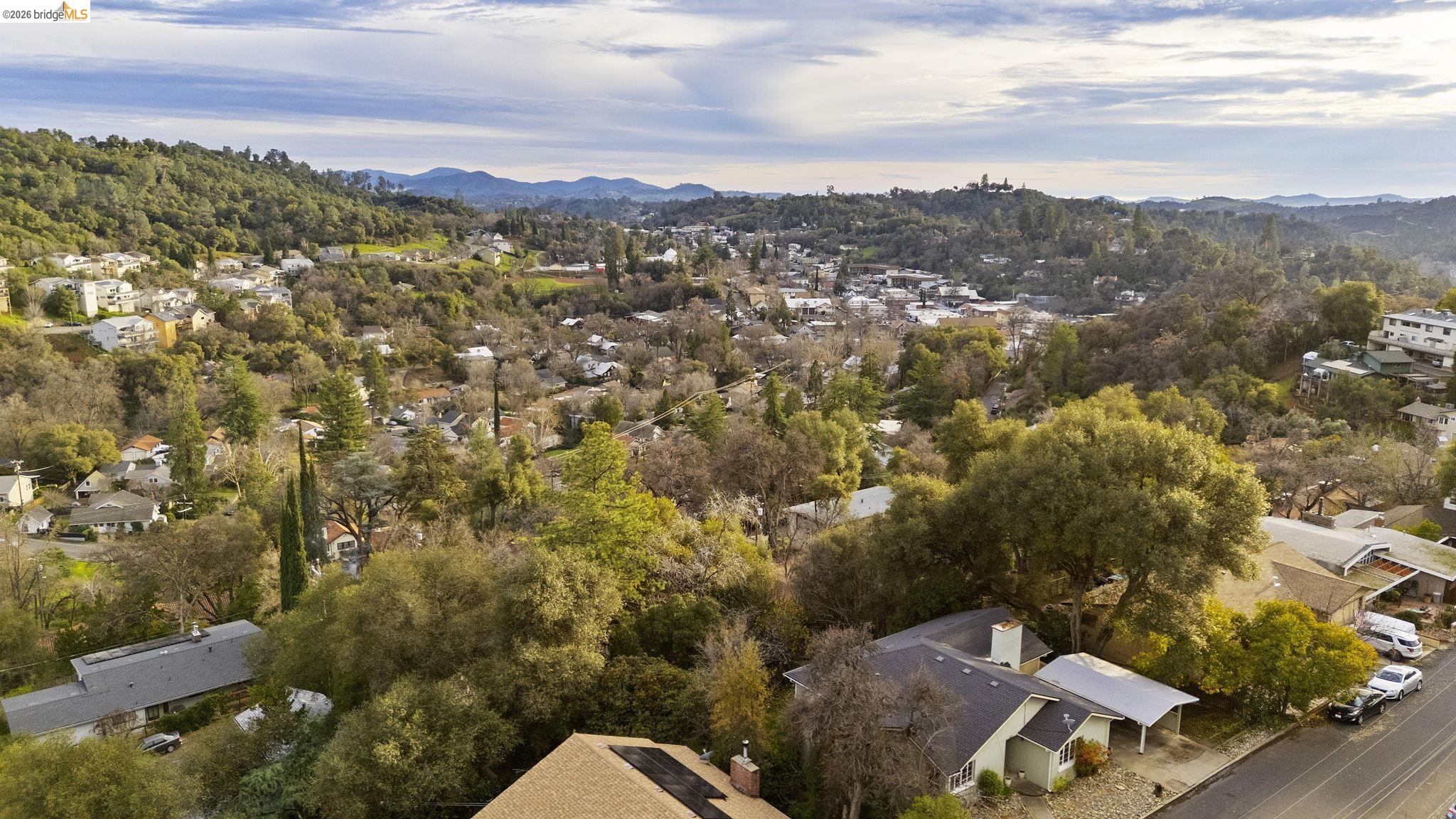 299 Summit Avenue Sonora, CA 95370 - Photo 35 of 38 Aerial overview of property's location with a mountain backdrop and nearby suburban area