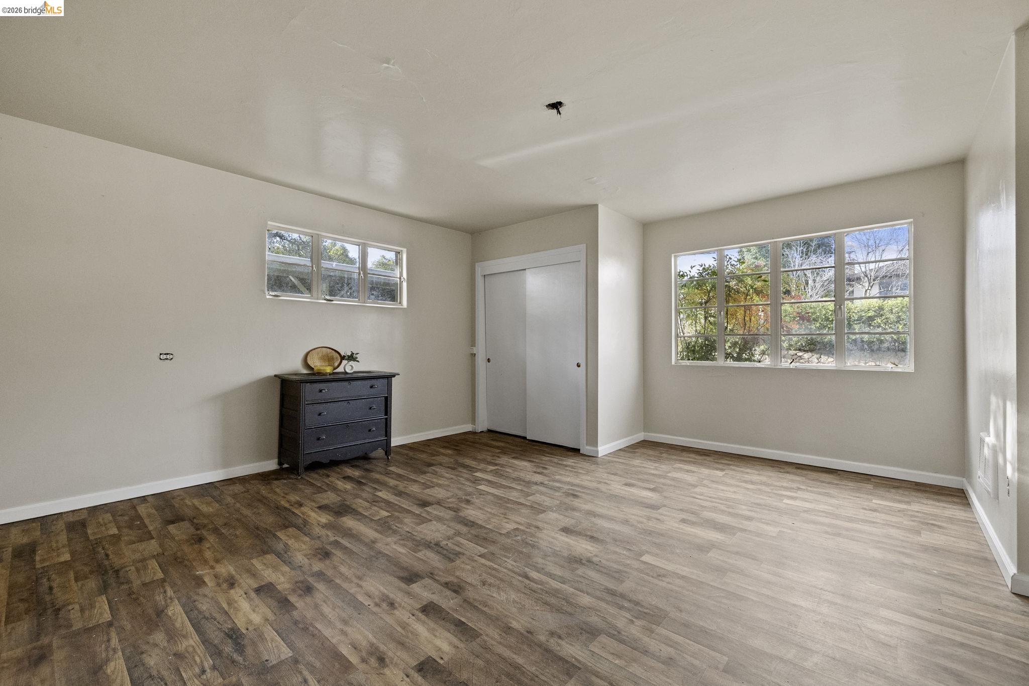 299 Summit Avenue Sonora, CA 95370 - Photo 6 of 38 Unfurnished bedroom with wood finished floors and a closet