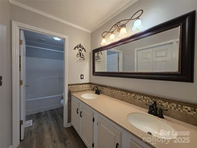 a bathroom with a double vanity sink and mirror