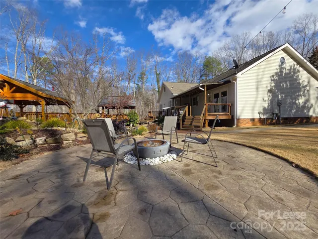 a view of a patio with table and chairs with wooden fence