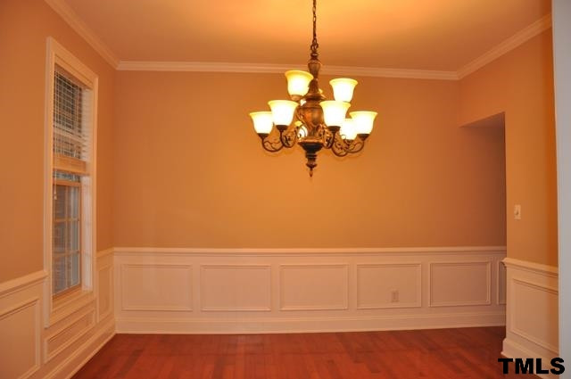 Gracious dining room-- chair railing, wainscoting, crown molding, hardwood floor Dining Room