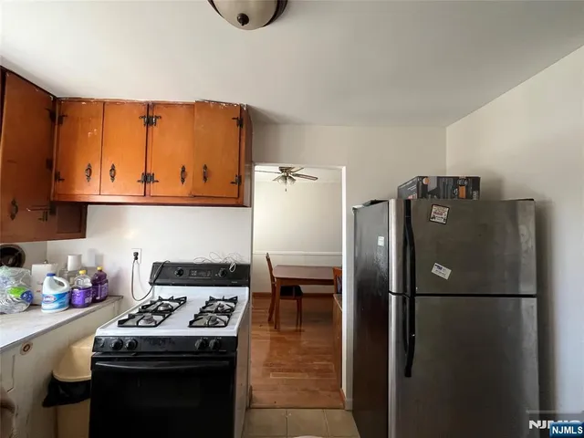 a kitchen with stainless steel appliances granite countertop a refrigerator and a stove