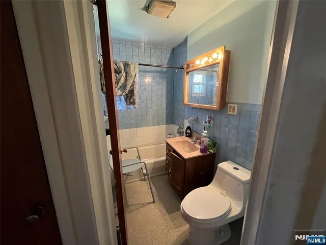 a bathroom with a toilet a sink and a mirror