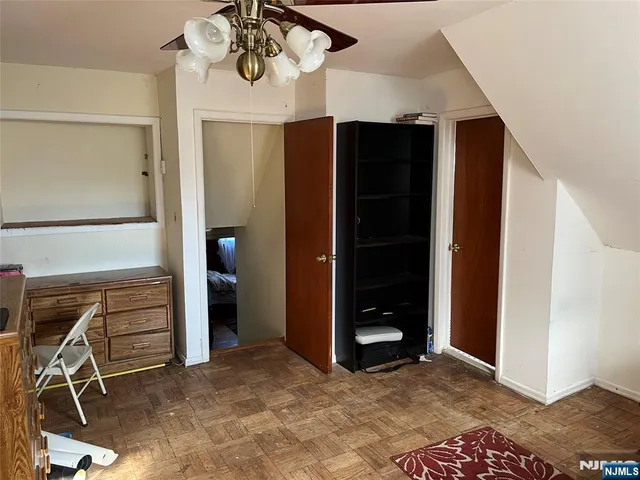 a view of an empty room with closet