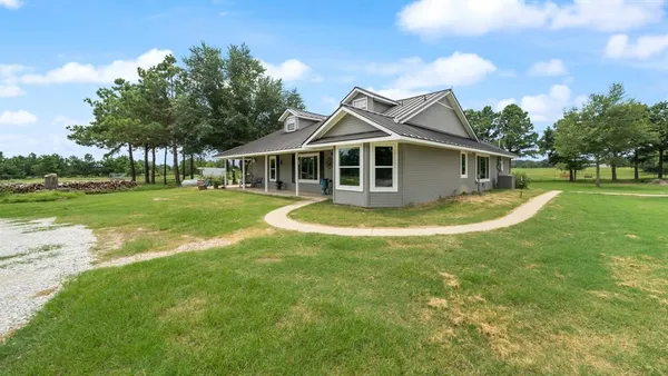 a view of a house with a yard patio and swimming pool