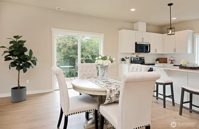 a view of a dining room with furniture window and wooden floor