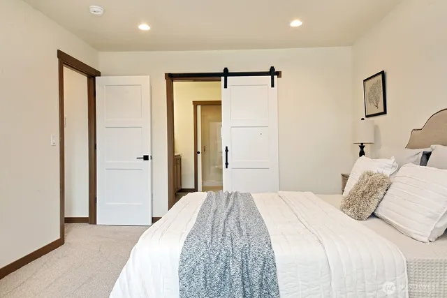 a bedroom with a bed and a shower