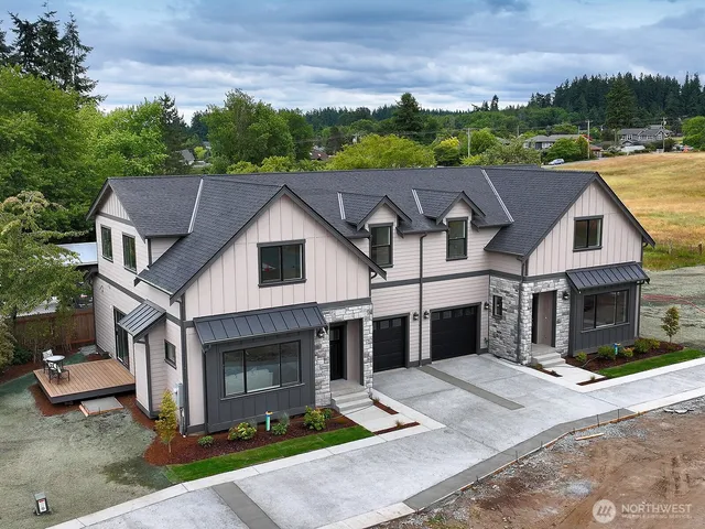 a aerial view of a house next to a yard
