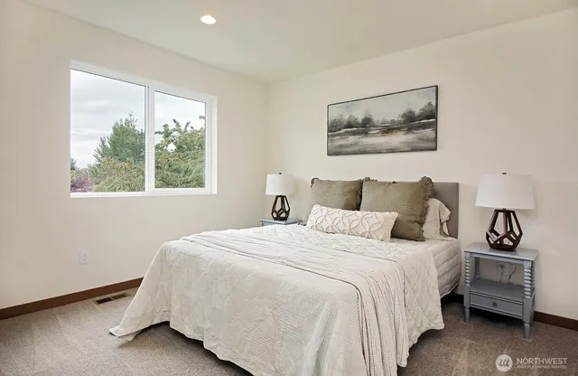 a bedroom with a bed and a window