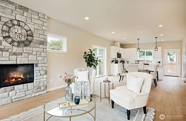 a living room with furniture a fireplace and a flat screen tv
