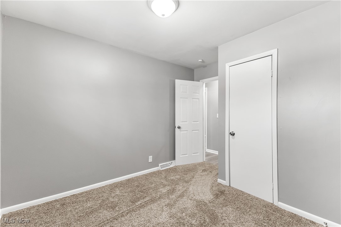 6161 Shaffer Road Northwest Warren, OH 44481 - Photo 12 of 20 Unfurnished bedroom with carpet floors and a closet