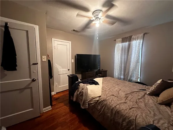 a bedroom with a bed and a flat screen tv