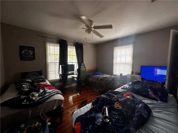 a bedroom with two beds and a window
