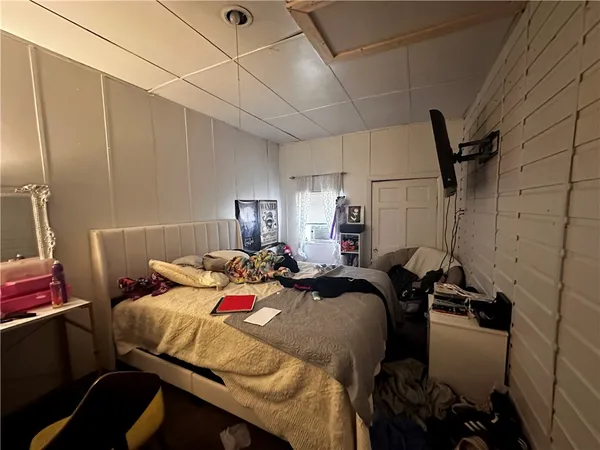 a bedroom with a bed and a gym equipment