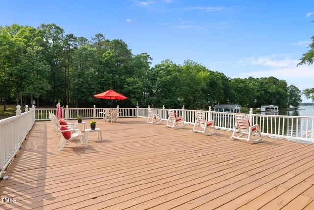 a kitchen with stainless steel appliances kitchen island granite countertop a table chairs in it and wooden floors