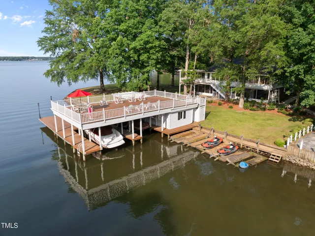 a view of house with lot of plants and trees