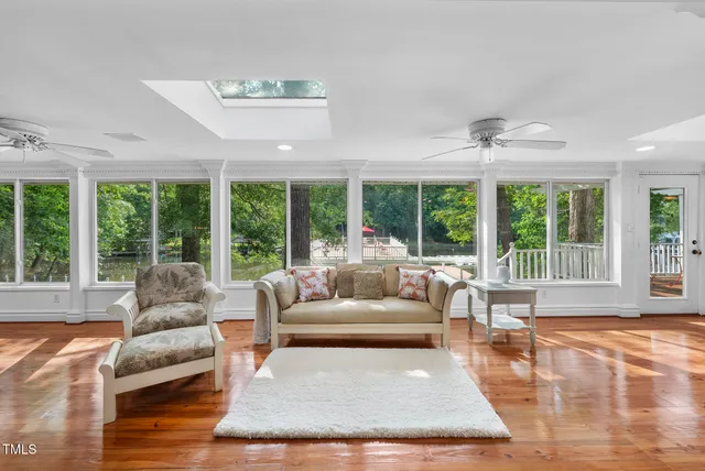 a view of a deck with chairs and wooden floor
