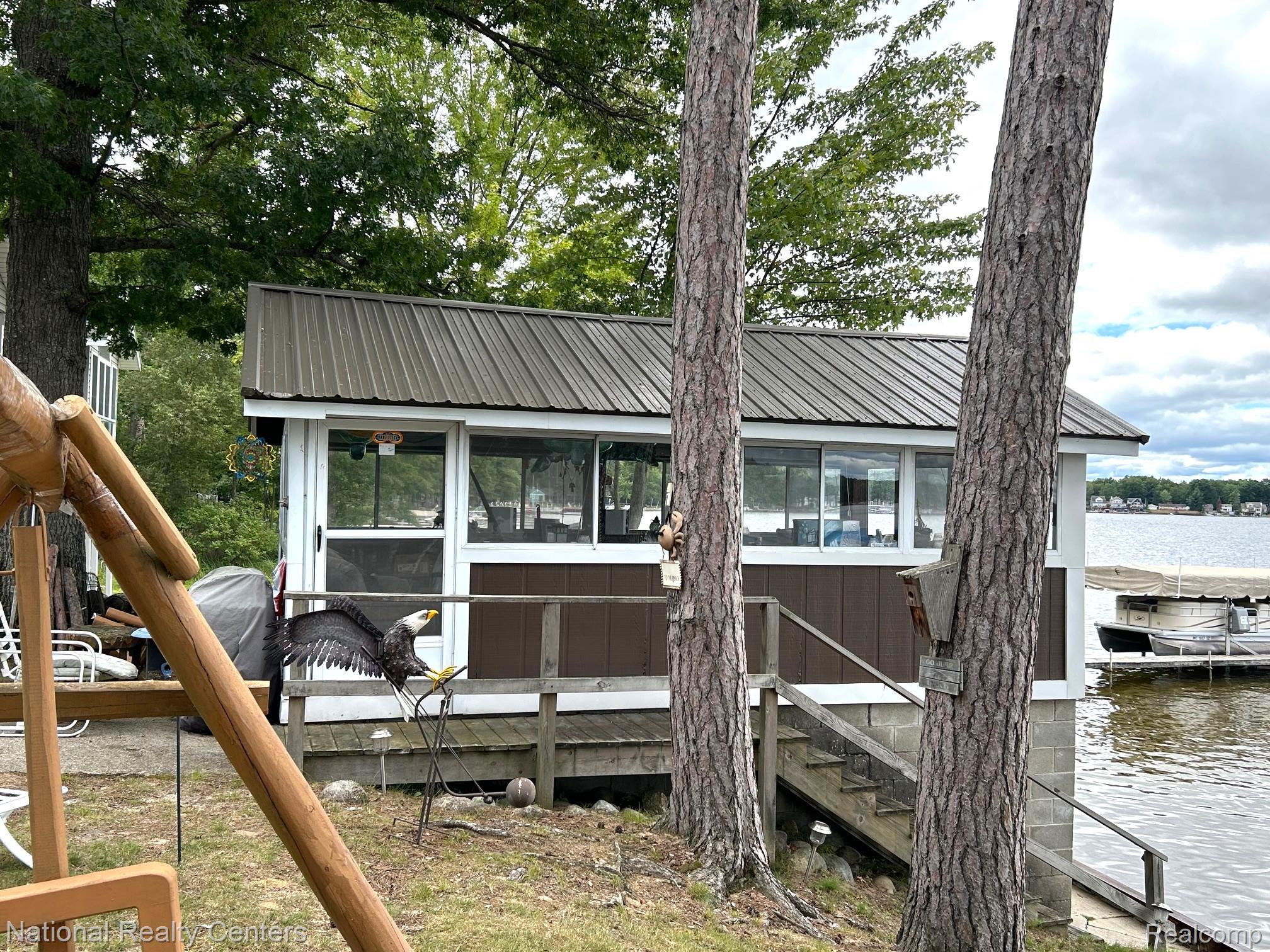4951 Kokosing Road Hale, MI 48739 - Photo 11 of 37 Dock area featuring a sunroom and a water view