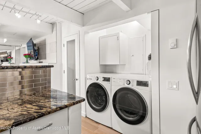 a kitchen with granite countertop a sink and a stove