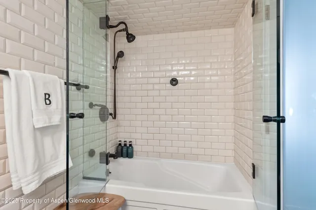 a bathroom with a bathtub and a shower