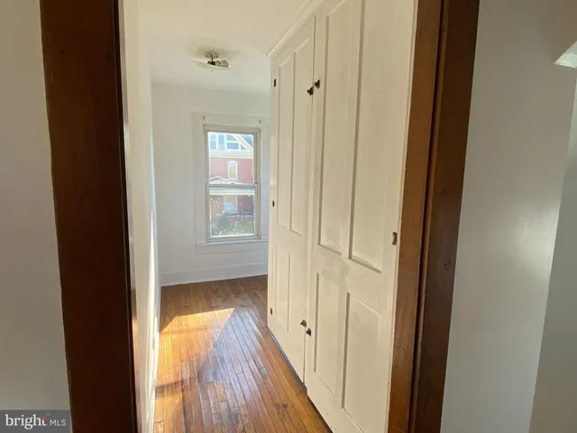 a view of a hallway with wooden floor